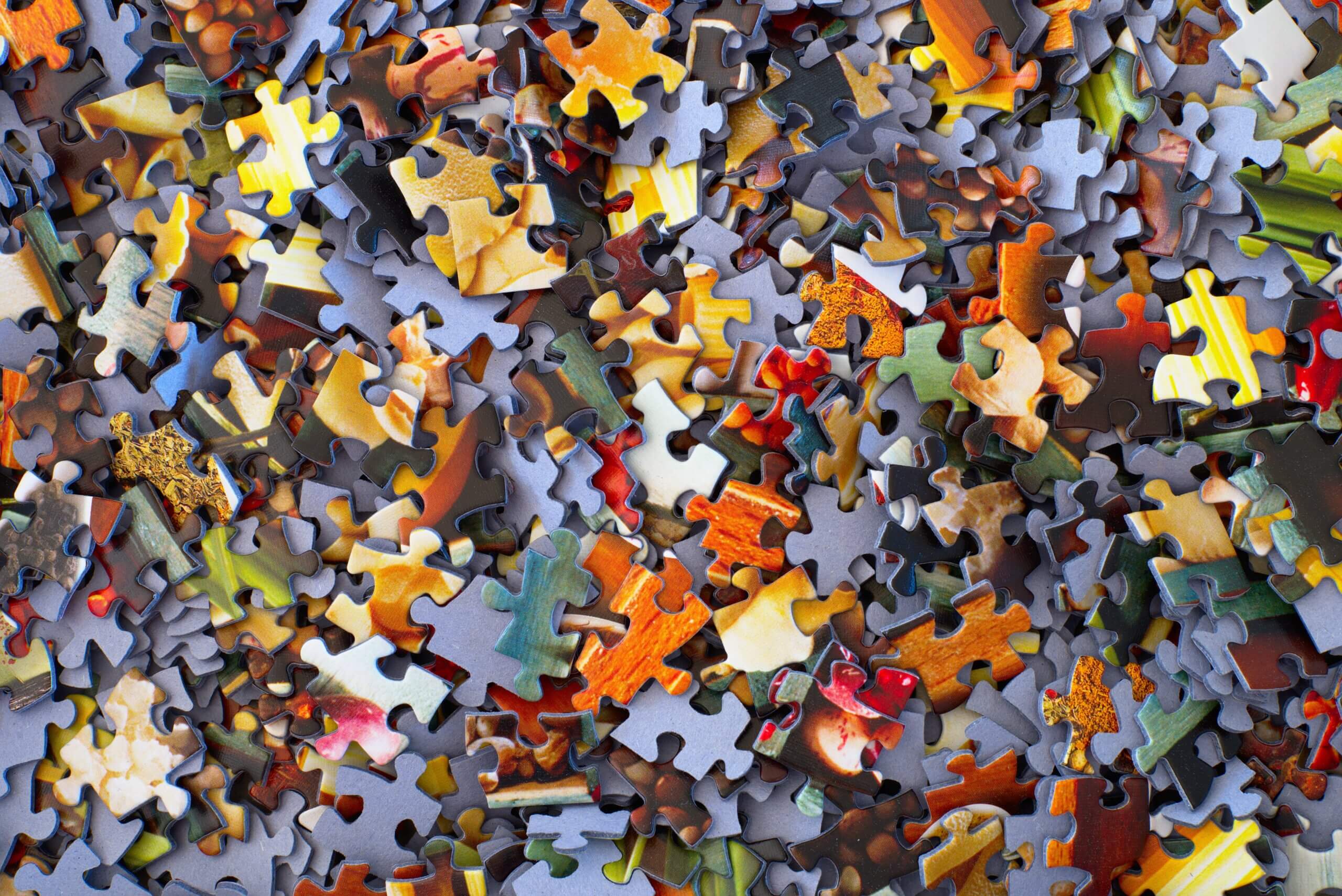 A jumbled mess of jigsaw puzzle pieces.